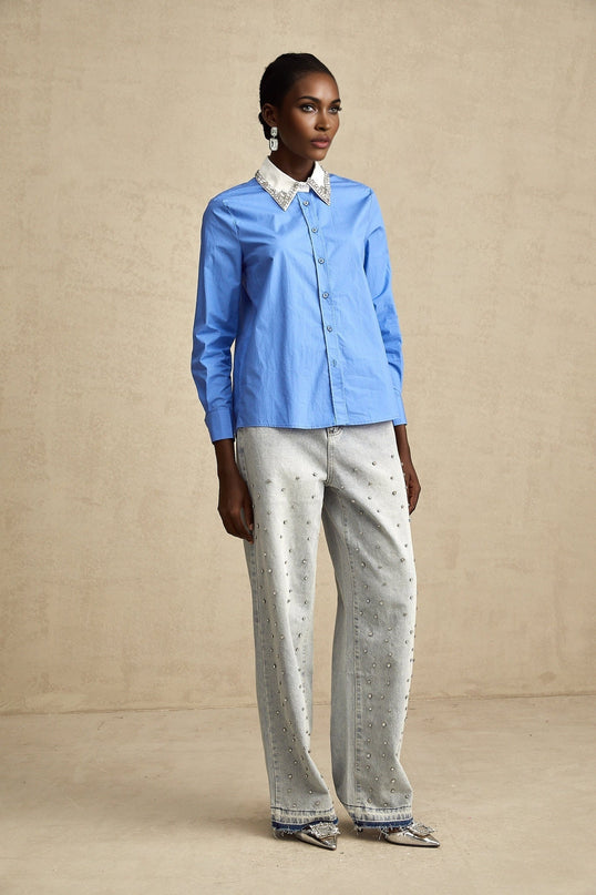 A blue colorblock shirt with rhinestone embellishments on the front featuring contrasting fabric sections and a casual fit