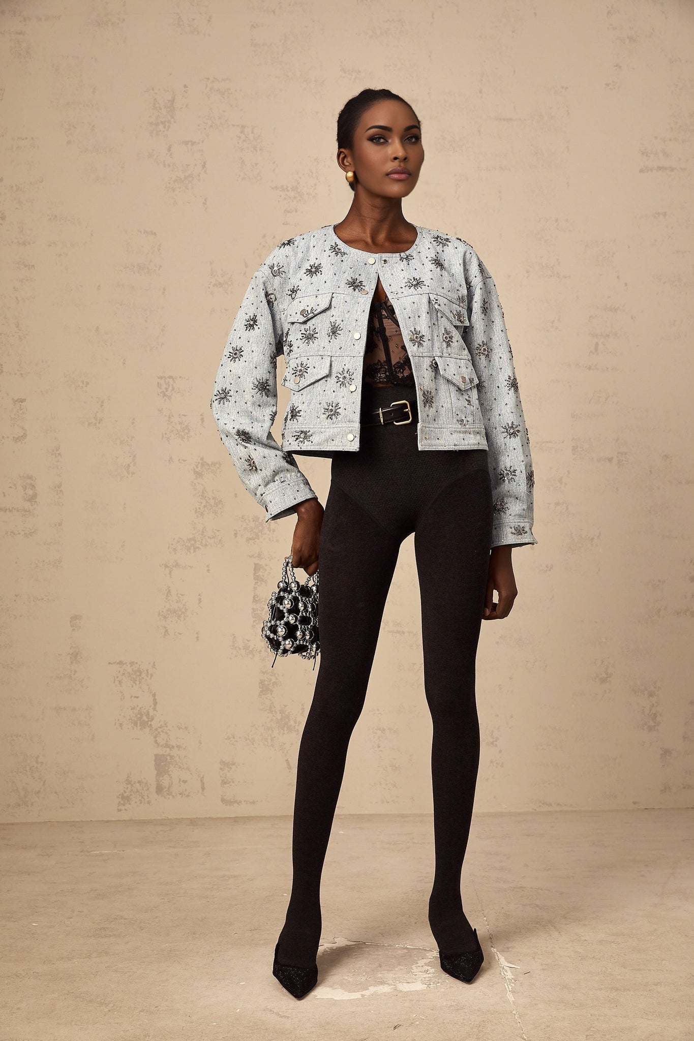 A blue denim jacket with studded sun designs decorating the fabric Katell brand