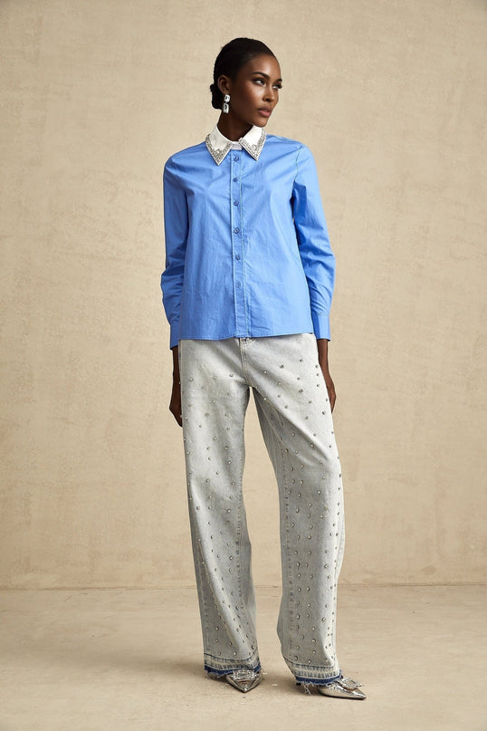 A blue dress shirt with rhinestone embellishments and color block design featuring contrasting panels