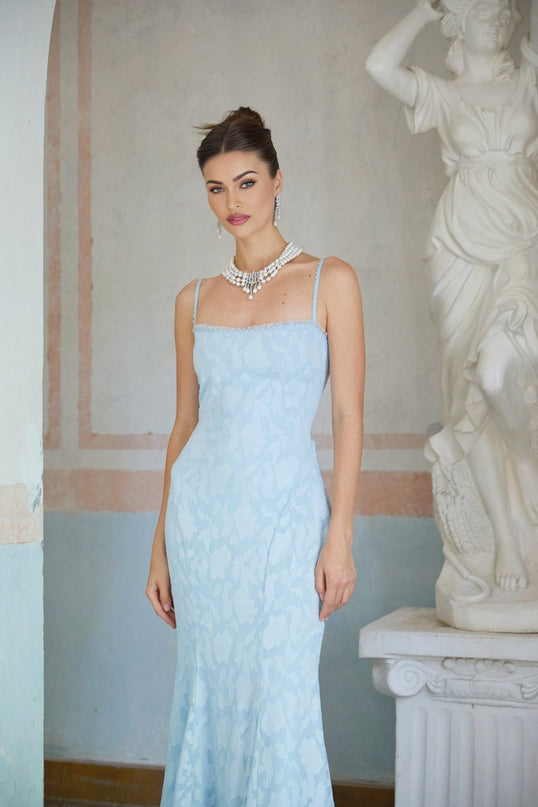 A blue flared maxi dress with laceup detail and jacquard pattern