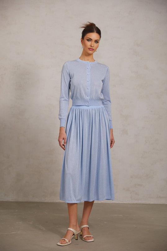 A blue knitted two piece outfit consisting of a top and skirt adorned with rhinestone embellishments The set features a matching design and is named Tiphaine