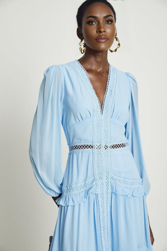 A blue maxi dress named Juno featuring cutout details and ruffles