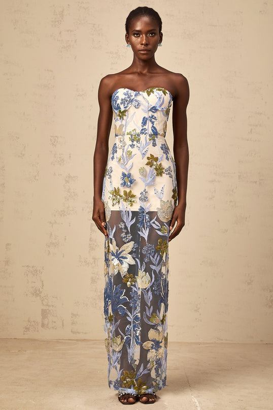 A blue maxi dress with a corset bodice adorned with sequined flower embroidery and a flowing tulle skirt