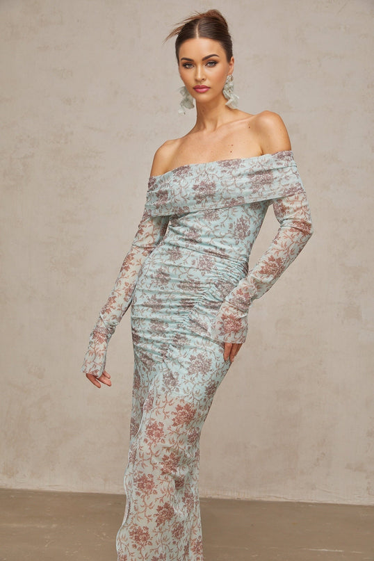 A blue maxi dress with a floral print pattern and ruched detailing by Honorine