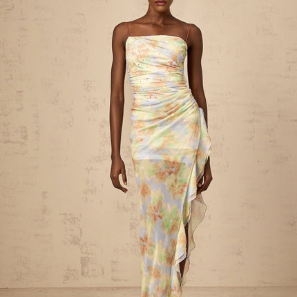 A blue maxi dress with an asymmetric design featuring a floral print and ruched detailing called Yseult
