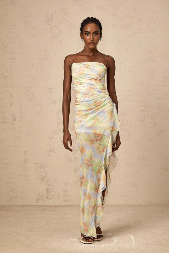 A blue maxi dress with an asymmetric design featuring a floral print and ruched detailing called Yseult