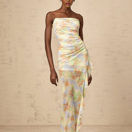 A blue maxi dress with an asymmetric design featuring a floral print pattern and ruched detailing named Yseult
