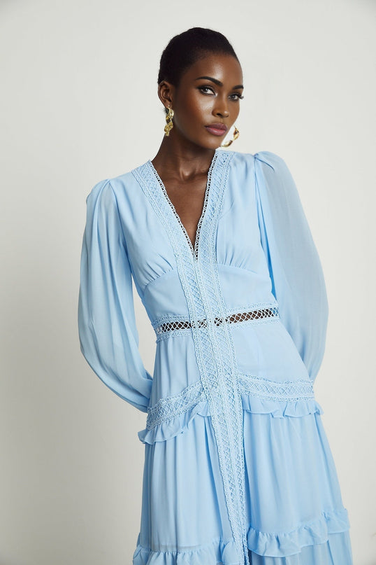 A blue maxi dress with cut out details and ruffles named Juno