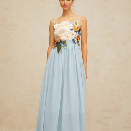 A blue maxi dress with floral embroidery and shirred detailing named Josette