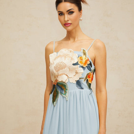 A blue maxi dress with floral embroidery and shirred detailing named Josette