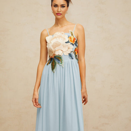 A blue maxi dress with floral embroidery and shirred detailing named Josette