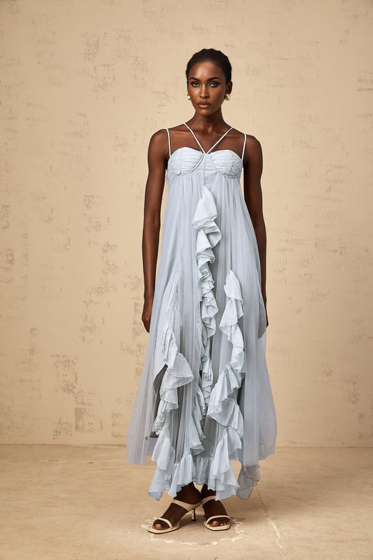 A blue maxi dress with layered ruffled tulle skirt and sleeveless bodice featuring a feminine silhouette and flowing design