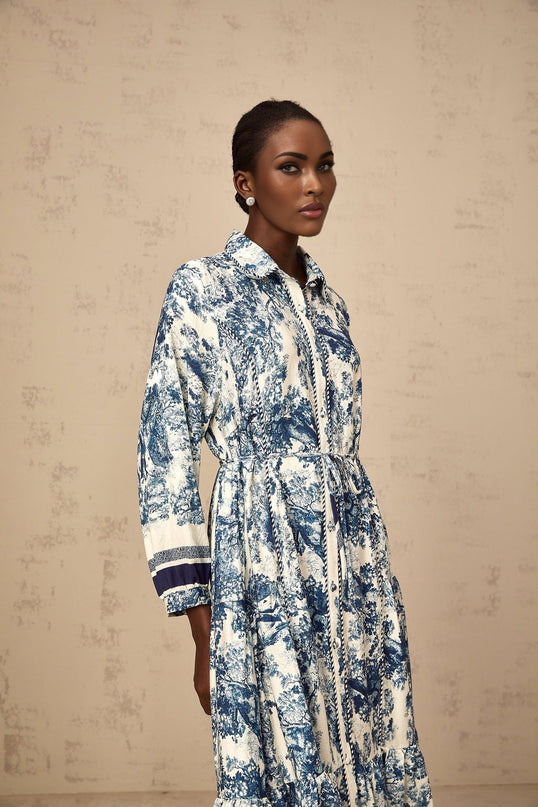 A blue midi dress with a graphic print pattern named Adelaide shown on a model or hanging display