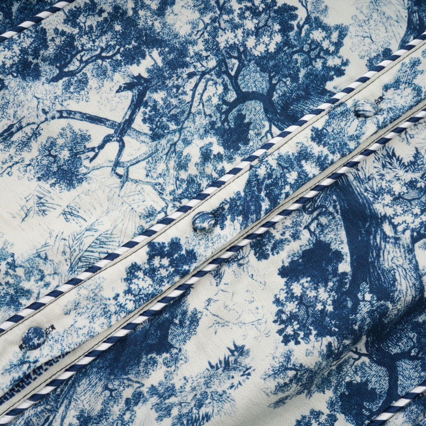 A blue midi dress with a graphic print pattern named Adelaide worn by a female model standing against a plain background