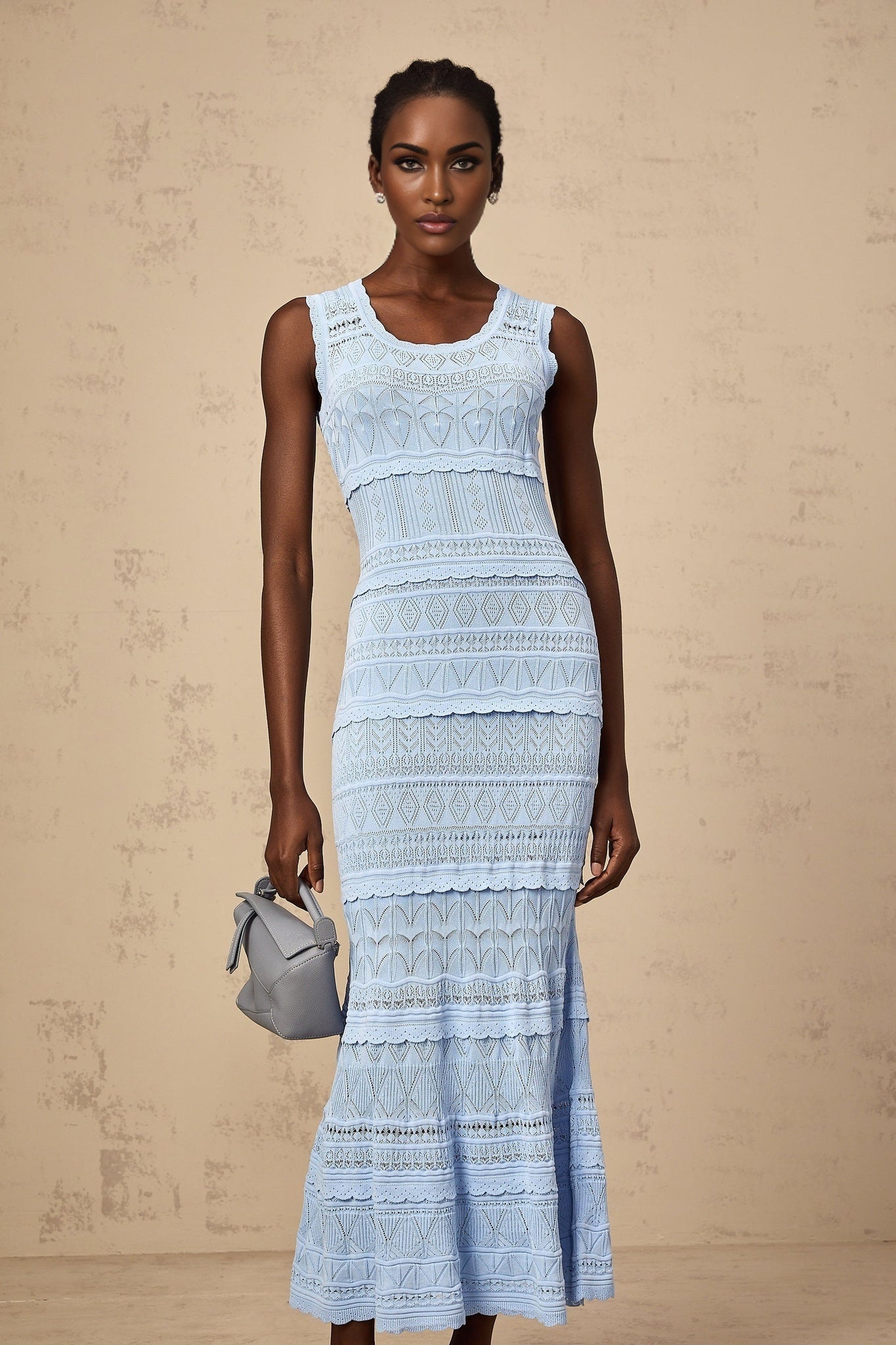 A blue midi dress with crochet knit detailing and ruffled trim accents