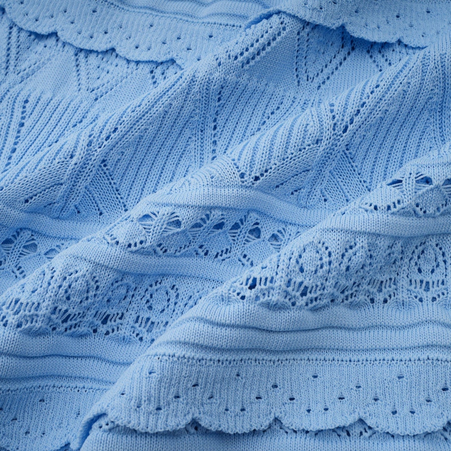 A blue midi dress with crochet knit pattern and ruffled trim details named Mailys