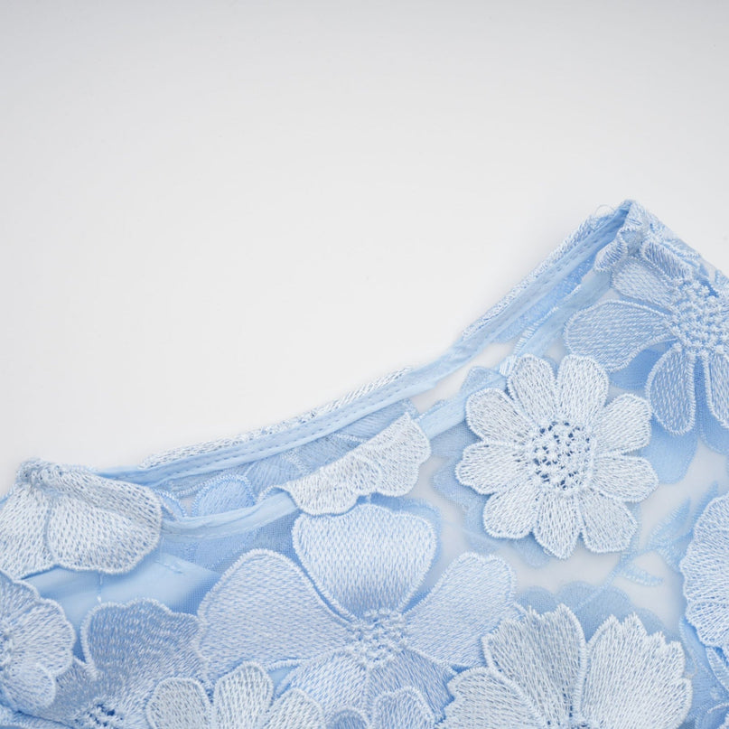 A blue midi dress with floral applique details by Herta