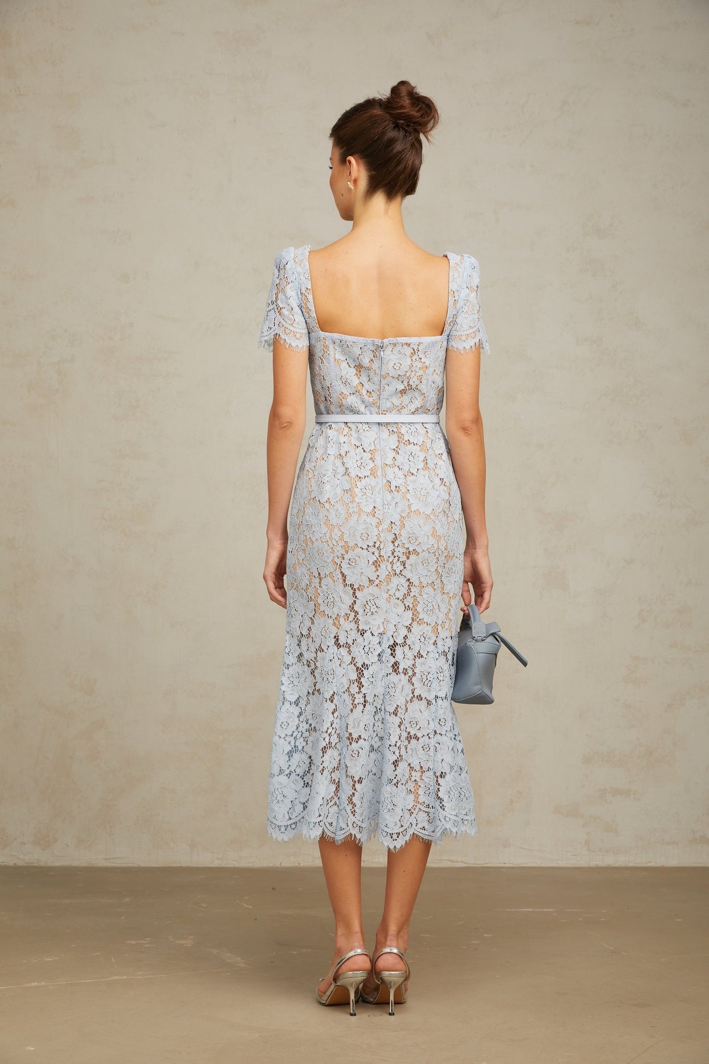 A blue midi dress with floral lace pattern and boned structure named Audrey