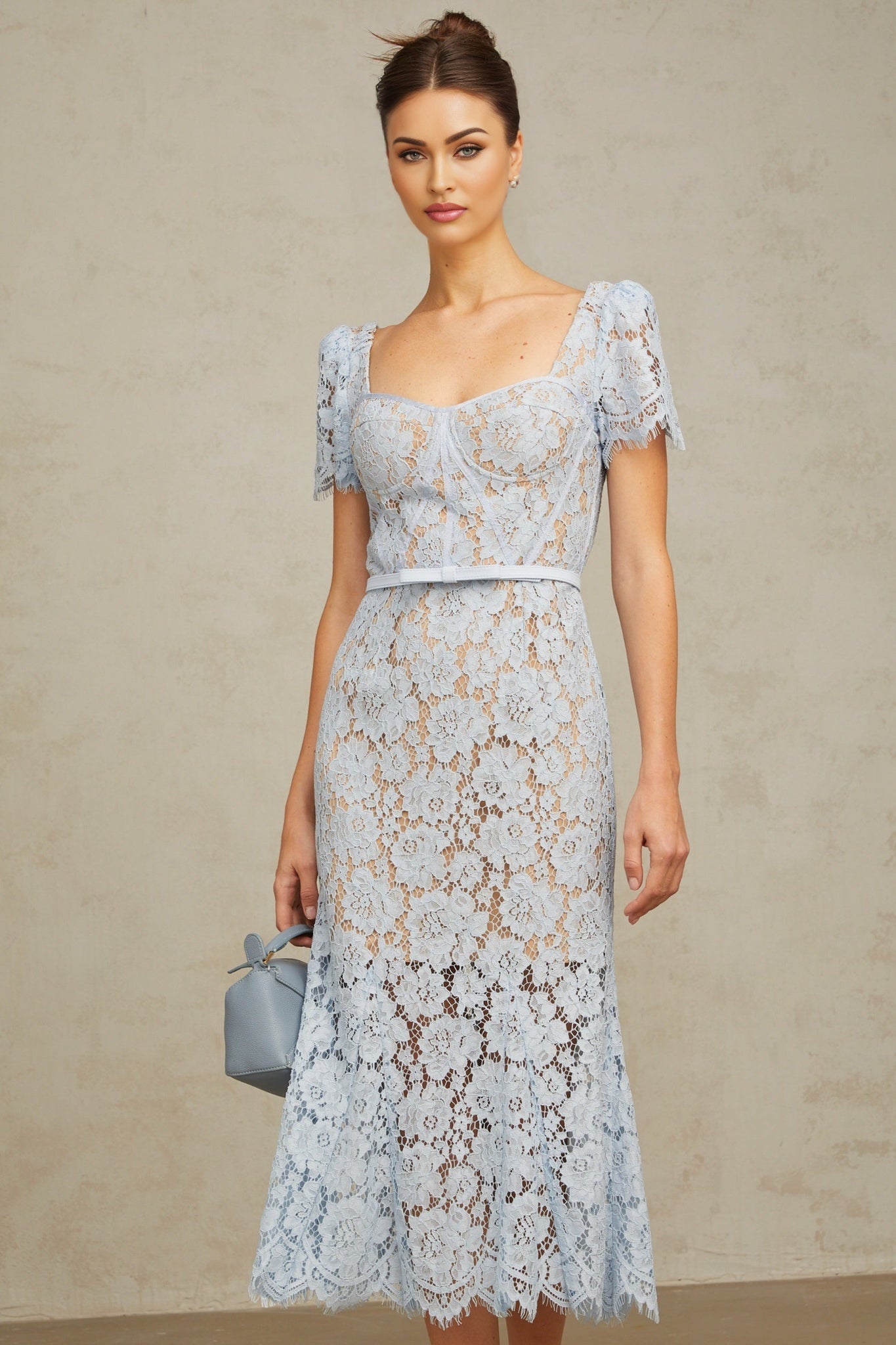 A blue midi dress with floral lace pattern featuring boned bodice and Audrey style design