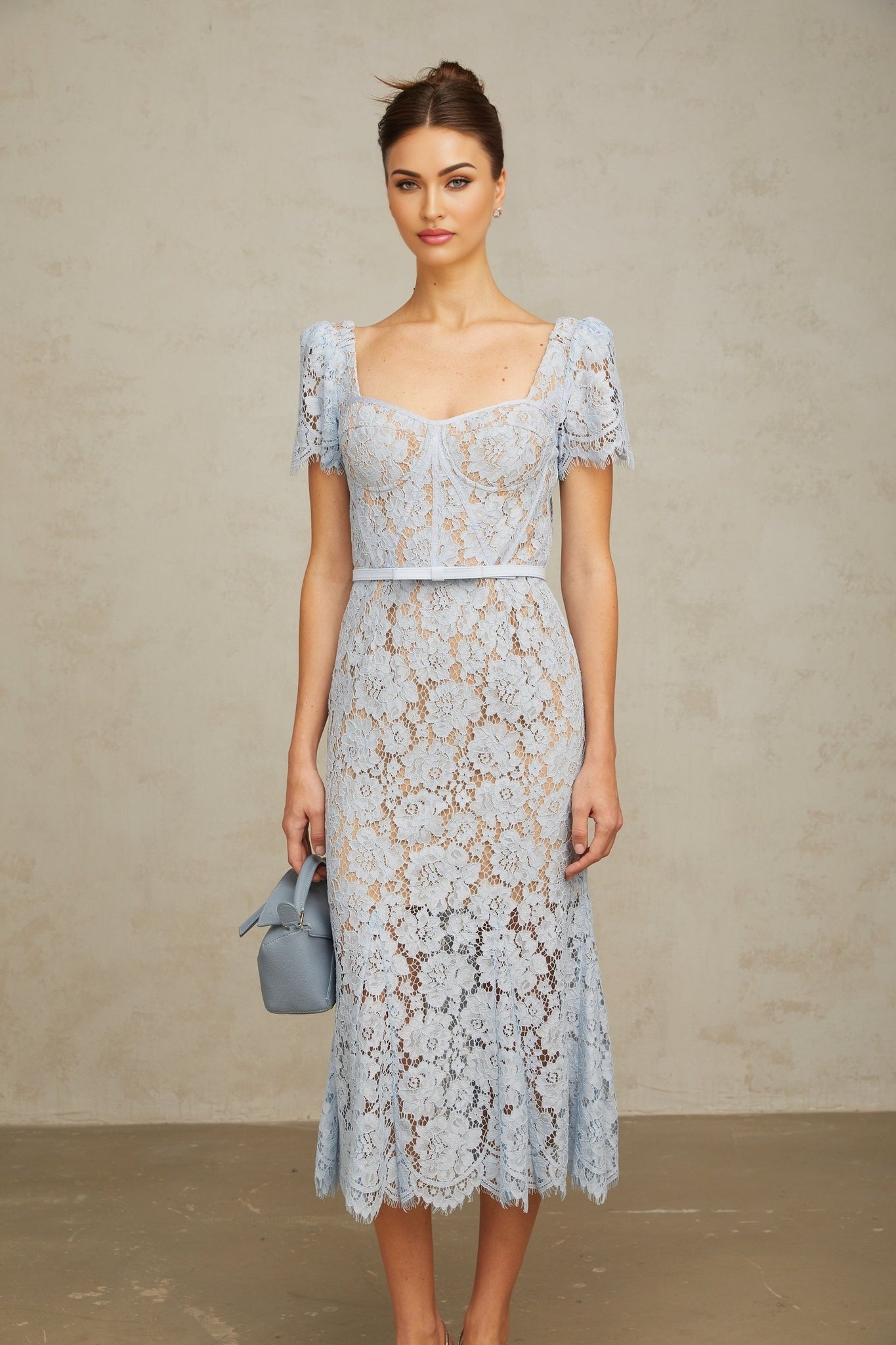 A blue midi dress with floral lace pattern featuring boned structure and named Audrey