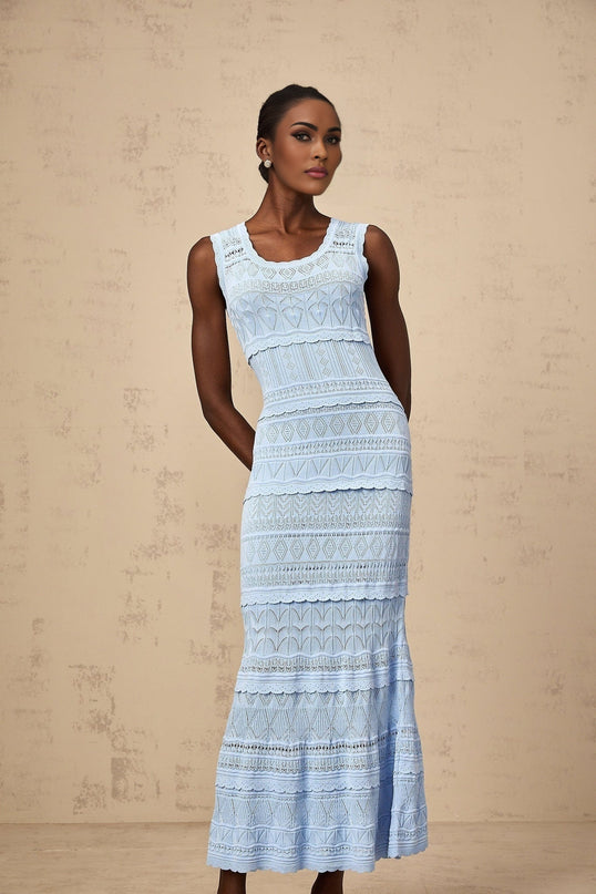 A blue midi dress with ruffled trim and crochet knit design featuring a feminine silhouette
