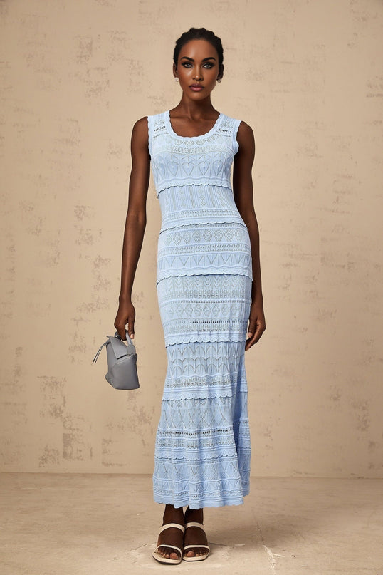 A blue midi dress with ruffled trim and crochet knit pattern featuring a feminine silhouette and delicate texture