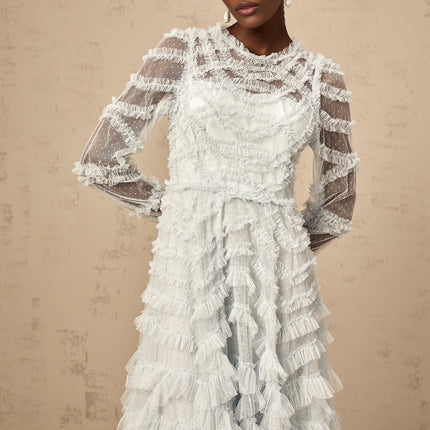 A blue midi dress with ruffles and small dot details named Adelaide