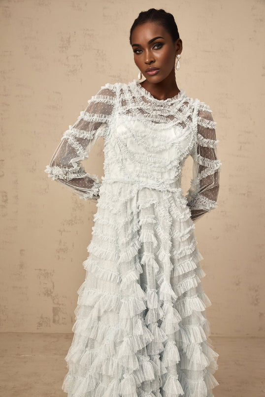 A blue midi dress with ruffles and small dot details named Adelaide