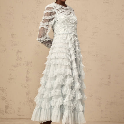 A blue midi dress with ruffles and small dot details named Adelaide