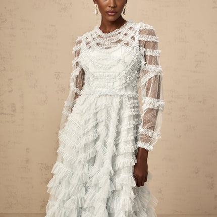 A blue midi dress with ruffles and small dot details named Adelaide