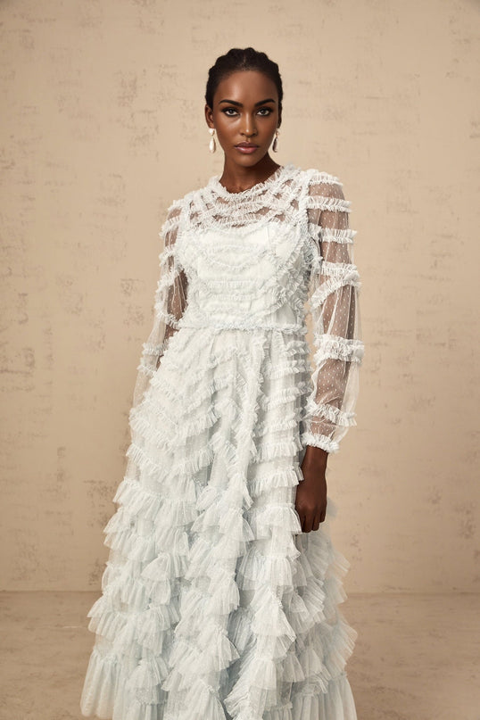 A blue midi dress with ruffles and small dot details named Adelaide