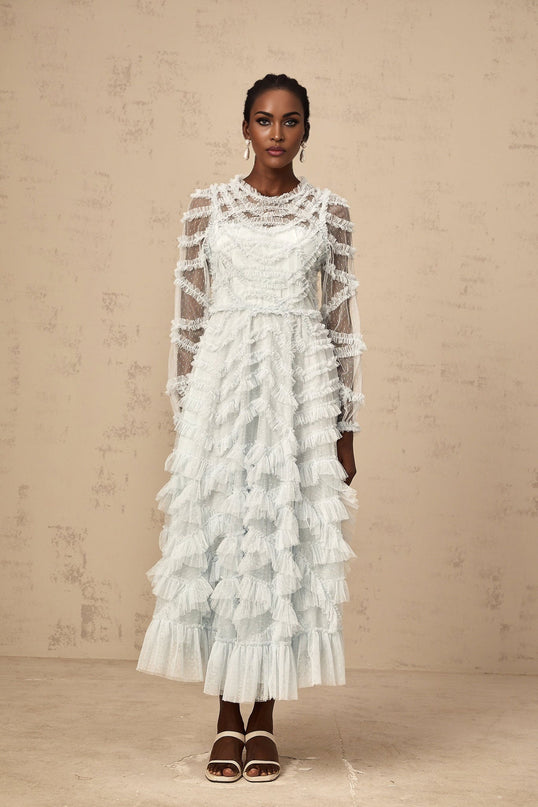 A blue midi dress with ruffles and small dot details named Adelaide