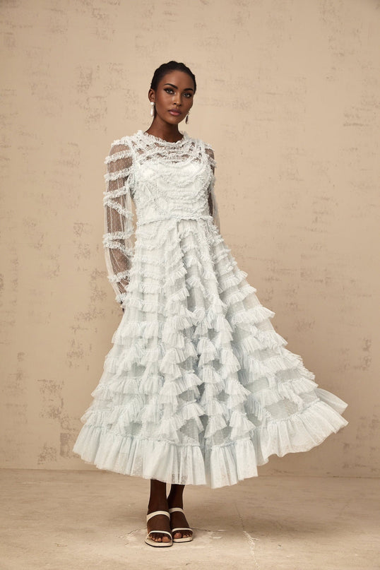 A blue midi dress with ruffles and small dot details named Adelaide