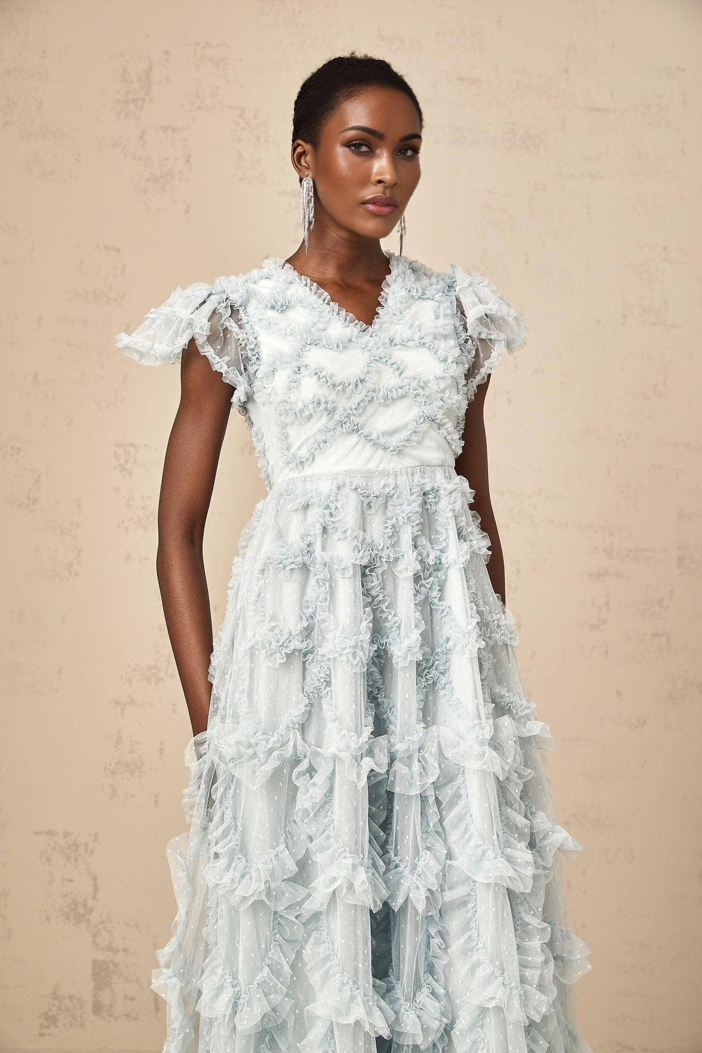A blue midi dress with ruffles and small dot details named Corinna