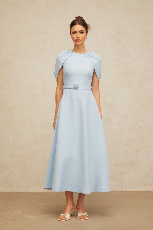 A blue midi dress with shawllike panels and embellishments named Lina featuring a flattering silhouette and elegant design details