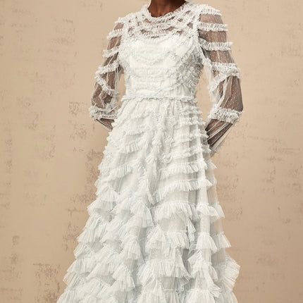 A blue midi dress with small white dots and ruffled details named Adelaide