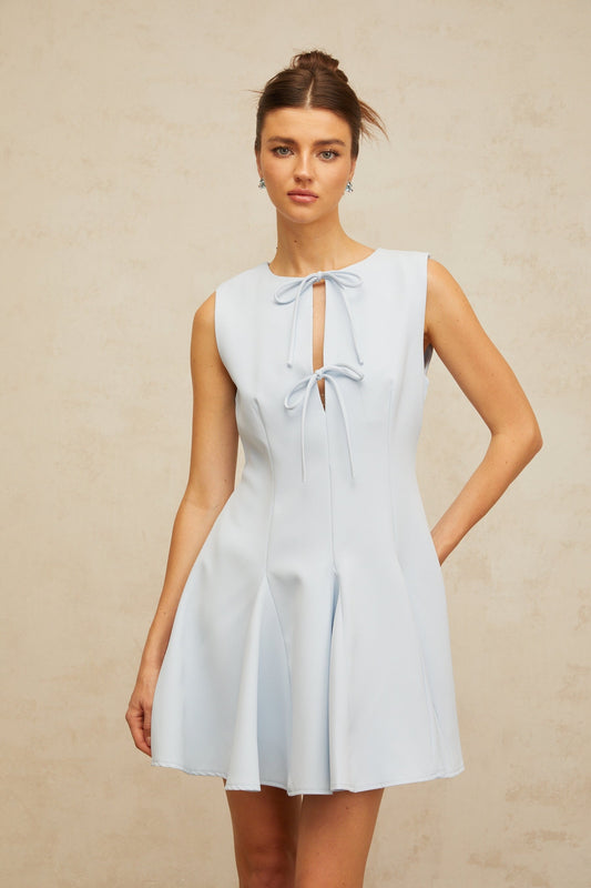 A blue mini dress with a bowknot detail and godet design featuring a flared skirt and short length