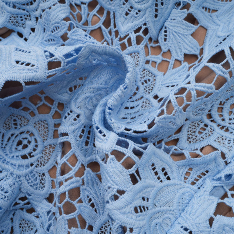 A blue mini dress with floral applique and ruffled lace details featuring a feminine and delicate design