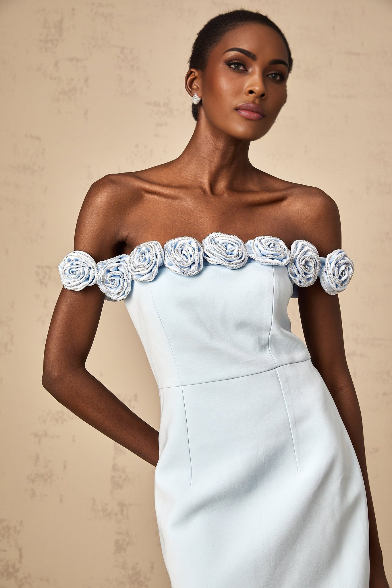 A blue mini dress with floral appliqués named Hedwige featuring a short hemline and decorative flower details