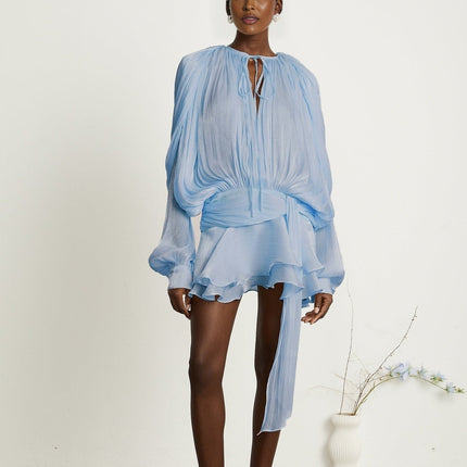 A blue mini dress with full pleats and ruffled details named Eugenie