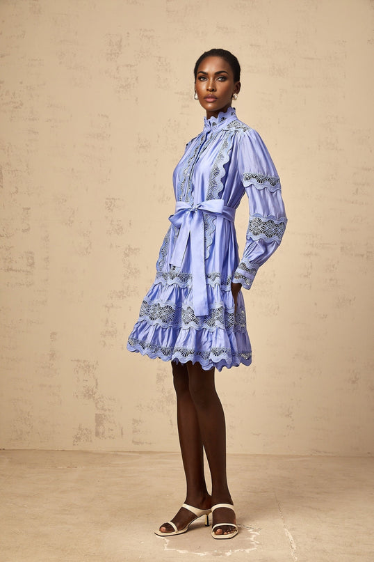 A blue mini dress with tiered layers and cut out embroidery details featuring a floral motif design