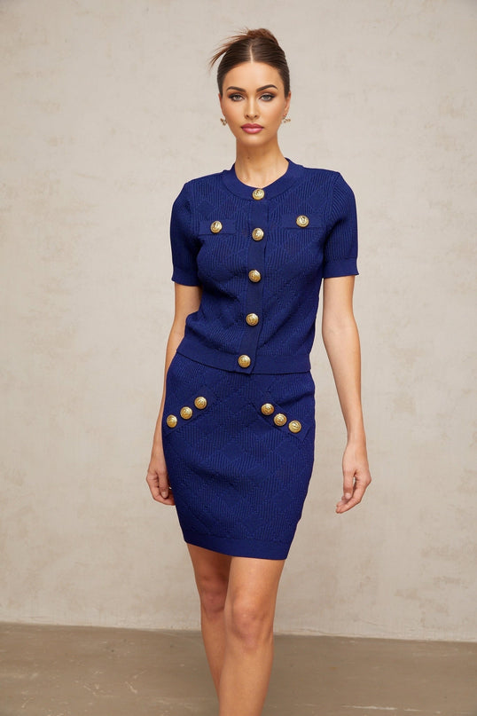 A blue plaidcheck knit matching set consisting of a top and skirt named Yseut