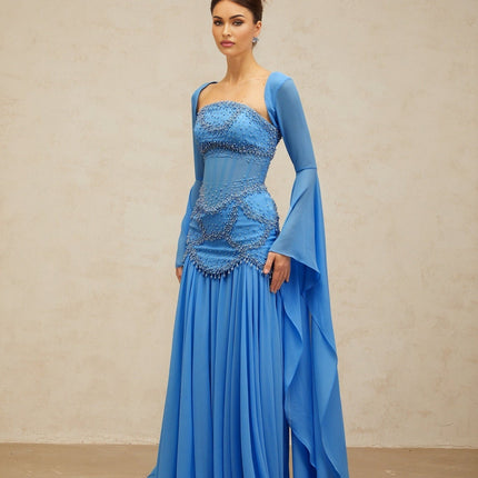 A blue pleated maxi dress with faux pearl embellishments by Gaelle