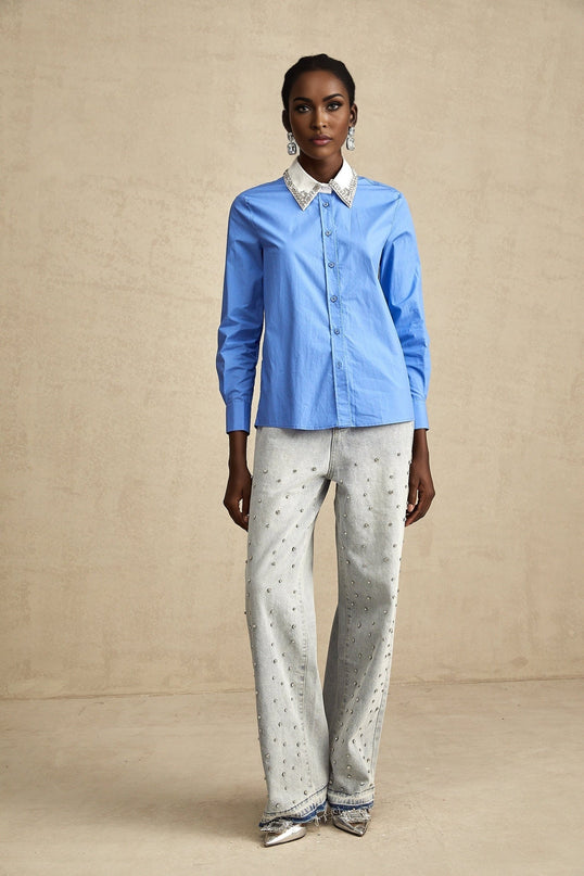A blue shirt with colorblock design featuring rhinestone embellishments and named Émilie