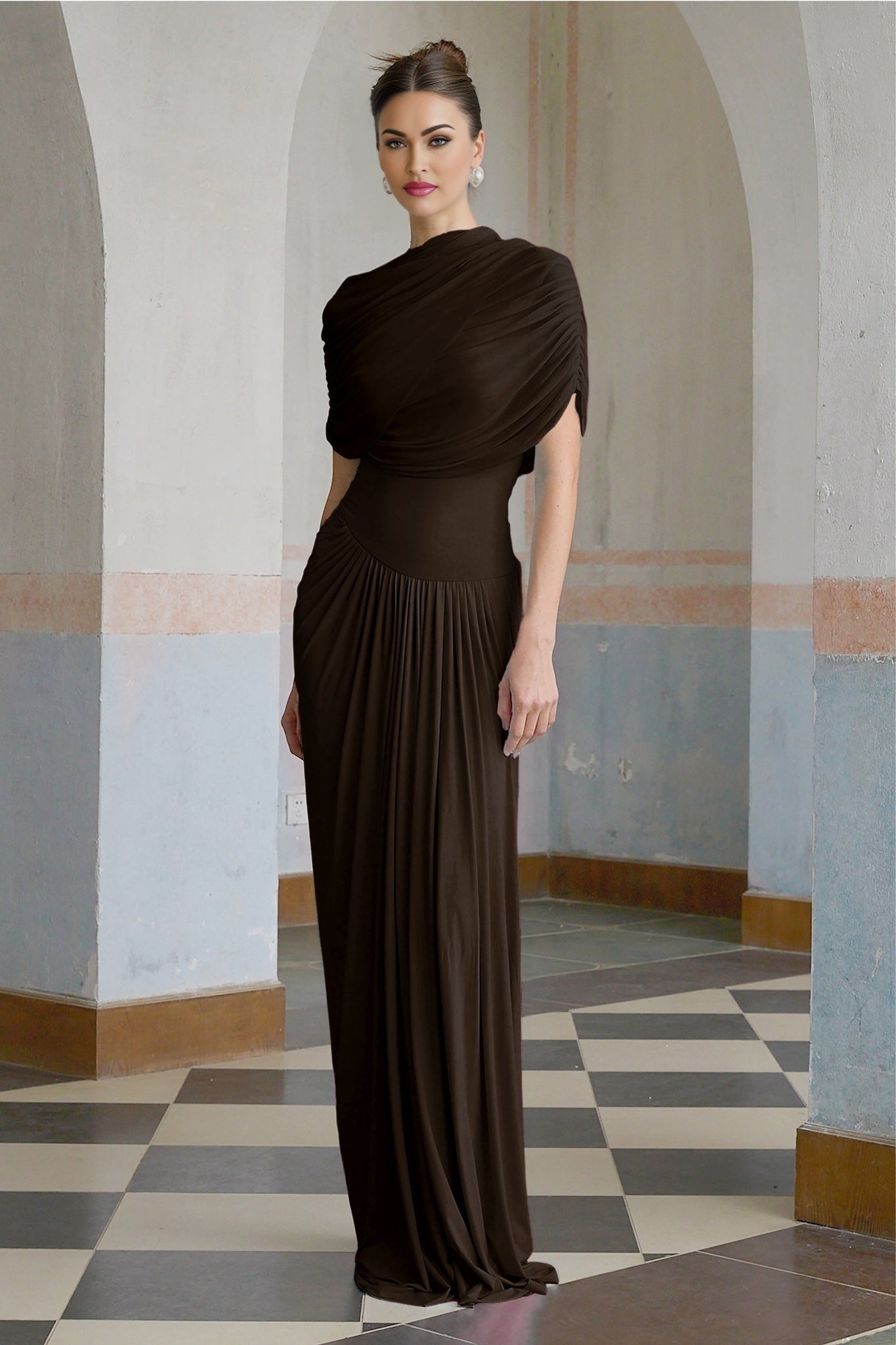 A brown asymmetric maxi dress with pleated details and a flowing silhouette