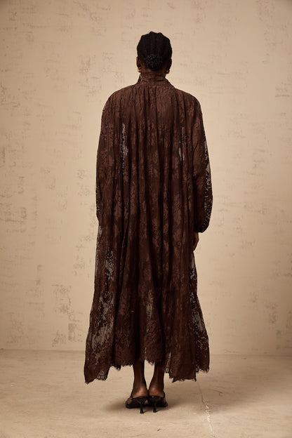 A brown flared midi dress made of chantilly lace named Sylvie with a fitted bodice and flowing skirt