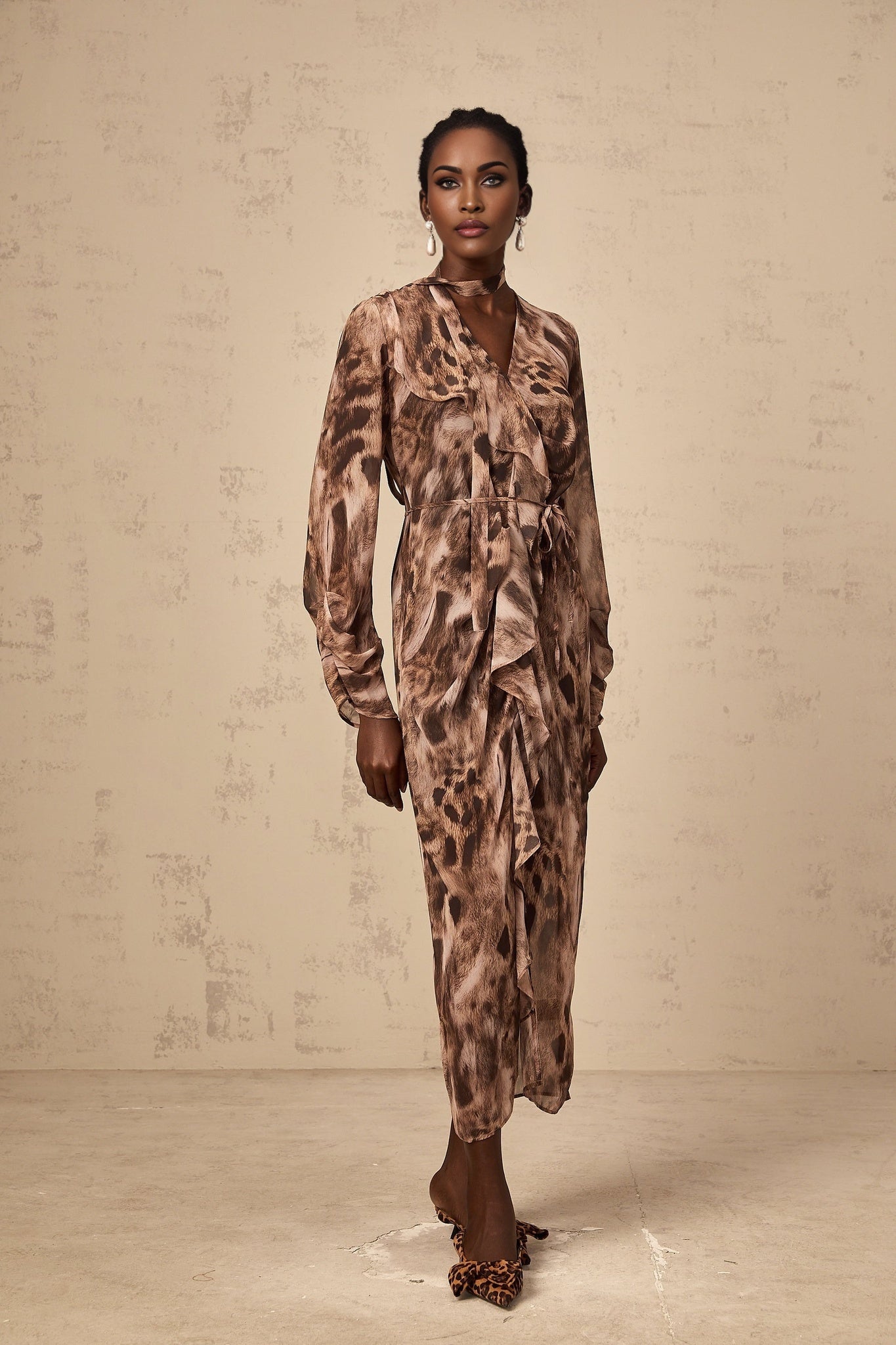 A brown midi dress with leopard print pattern and ruffled details named Sidonie