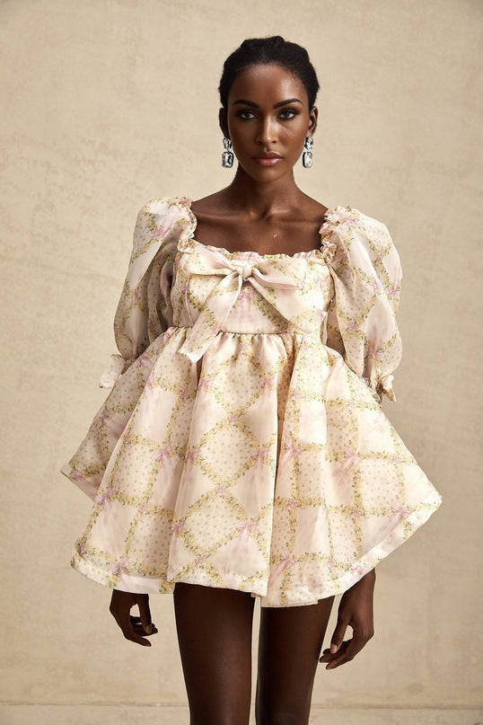 A checkered mini dress with puffy sleeves and a bow detail featuring a short hemline and a Lou style design