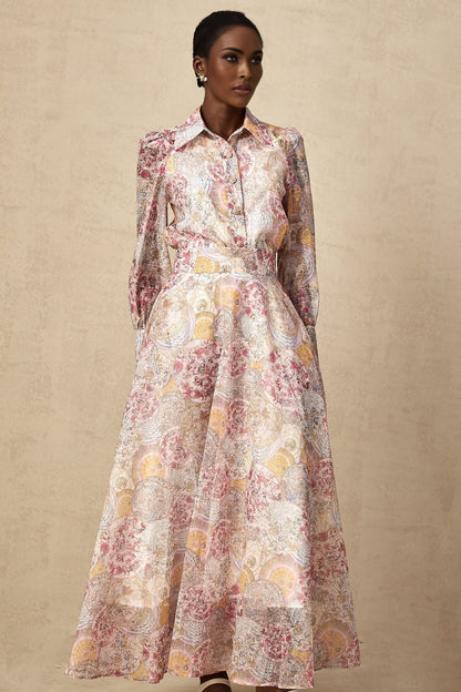 A child wearing a cherry pink shirt and skirt set with a pattern print design The top and bottom match creating a coordinated outfit
