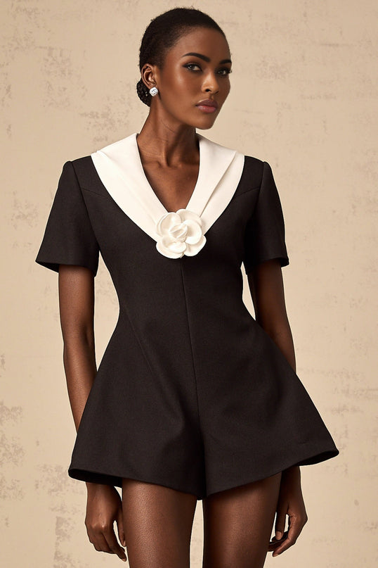 A colorblocked jumpsuit featuring floral applique details with contrasting colors and a fitted silhouette